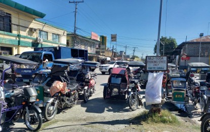 <p><strong>CASH AID</strong>. Tricycles parked at the terminal near the municipal hall in Mangatarem, Pangasinan. Tricycle drivers have lamented the decline in their earnings because of the pandemic but some have acknowledged the help of the cash aid being provided by the government.<em> (Photo by Joann Santiago-Villanueva)</em></p>