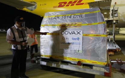 <p><strong>LATEST VAX ARRIVAL</strong>. An airport personnel checks the cargo containing the 193,050 doses of Pfizer Covid-19 vaccine donated through the COVAX Facility at the NAIA Terminal 2 in Pasay City on Monday (May 10, 2021). The Department of Health said the first batch of Pfizer vaccines would be distributed in Covid-19 high-risk areas in Metro Manila, Cebu, and Davao. (PNA photo by Joey O. Razon)</p>