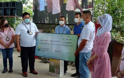 <p><strong>LAND TITLE</strong>. Agrarian Reform Secretary John R. Castriciones turns over a check to the San Luis ARBs for common service facilities under the Climate Resilient Farm Productivity Support program. Castriciones was in Iloilo Saturday (May 15, 2021) for the distribution of Emancipation Patents and Certificate of Land Ownership Awards and other support services to agrarian reform beneficiaries in Panay and Guimaras. <em>(Photo courtesy of Philippine Information Agency)</em></p>