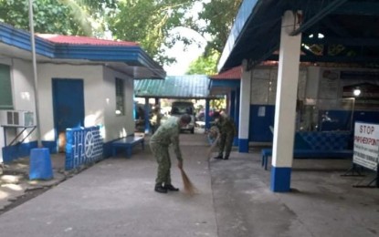 <p><strong>CLEANUP.</strong> Personnel of E.B. Magalona Municipal Police Station in Negros Occidental sweep the surroundings of their headquarters on Saturday (May 15, 2021). On Friday night, National Police Commission-Western Visayas regional director Joseph Celis reported that during his inspection, he found the station personnel sleeping and the headquarters with an unpleasant odor. <em>(Photo courtesy of E.B. Magalona MPS)</em></p>