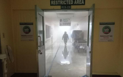 <p><strong>FIRE OUT.</strong> A firefighter inspects the operation room sanitization area on the third floor of the Philippine General Hospital central block building after it was hit by a fire early Sunday morning (May 16, 2021). The Bureau of Fire Protection is still investigating the cause of the fire which reached second alarm before it was declared under control at 2:46 a.m.<em> (Photo courtesy of BFP-Manila)</em></p>