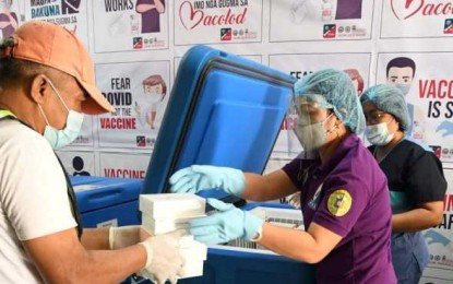 <p><strong>COVID-19 JABS</strong>. Personnel of Bacolod City Health Office store the 3,000 doses of Sinovac’s CoronaVac jabs that arrived on Tuesday (May 18, 2021), at the city’s cold room facility. The vaccines will be rolled out for the remaining frontline healthcare workers, senior citizens, and adults with comorbidities. <em>(Photo courtesy of Bacolod City PIO)</em></p>