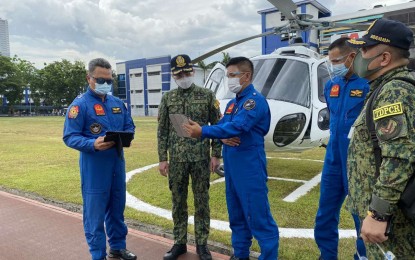 <p><strong>MISSION-READY SOON.</strong> PNP chief Gen. Guillermo Eleazar (center) takes a look at the training plan of Special Action Force (SAF) pilots at the Camp Crame Transformation Oval on May 10, 2021. Eleazar said the initial pool of SAF's helicopter pilots will be mission-ready by July. <em>(Photo courtesy of PNP Logistics Support Service)</em></p>