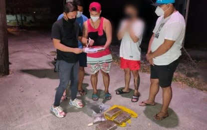 <p><strong>BUSTED</strong>. Pampanga policemen arrest two suspected drug peddlers in a drug sting in Mabalacat City, Pampanga on Wednesday (May 19, 2021). Seized from the suspects were suspected dried marijuana leaves with fruiting tops worth some PHP420,000.<em> (Photo courtesy of PRO-3)</em></p>