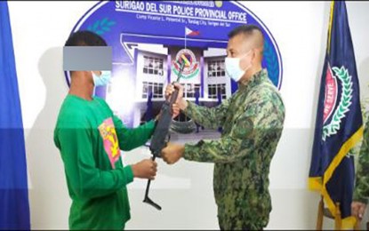 <p><strong>BACK TO THE FOLD.</strong> Surigal del Sur Police Provincial Office (SDSPPO) director, Col. James T. Goforth, welcomes alias 'Bunso,' a member of the Guerrilla Front 30 of the New People's Army, during a surrender ceremony on May 14, 2021 in Tandag City. 'Bunso' is one of the 17 rebels who surrendered to SDSPPO on the same day. <em>(Photo courtesy of SDSPPO)</em></p>