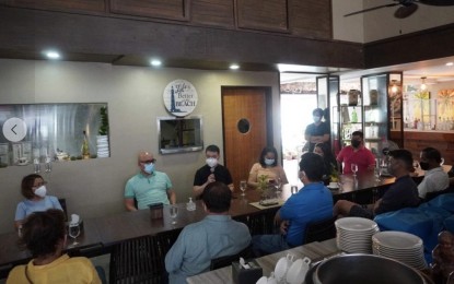 <p><strong>REOPENING BORACAY</strong>. Photo shows Undersecretary Anthony Gerard Gonzales (holding microphone) leading other officials in discussing with Malay town officials the possible reopening of Boracay amid the Covid-19 pandemic. Gonzales on Thursday (May 20, 2021) says the Office of the Presidential Assistant for the Visayas will help the LGU in its quest to again welcome visitors into the tourist island.<em> (Photo courtesy of OPAV)</em></p>