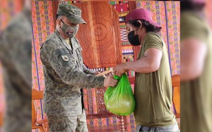 <p><strong>NEW LIFE.</strong> Maj. Gen. William Gonzales, Joint Task Force Sulu commander, hands over a food pack to an Abu Sayyaf Group surrenderer on Thursday (May 20, 2021) in Talipao, Sulu. Eight former bandits will receive assistance through a localized integration program.<em> (Photo courtesy of JTF Sulu Public Affairs Office)</em></p>