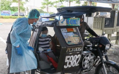 <p><strong>NO CAR, NO PROBLEM.</strong> A tricycle brings a Makati City resident to the Ayala Circuit drive-thru facility on Friday (May 21, 2021). Several local government units are providing free shuttle services to encourage more to get vaccinated. <em>(Photo courtesy of Makati-PIO)</em></p>