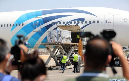 <p><strong>NEW VAX MAKER.</strong> Airport staff members unload the first batch of Chinese Sinovac vaccine raw materials at the Cairo International Airport in Egypt on May 21, 2021. A new shipment of China's Sinopharm Covid-19 jabs was also delivered. <em>(Xinhua/Sui Xiankai)</em></p>