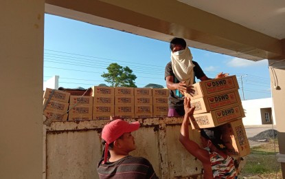 <p><strong>TYPHOON AID.</strong> Workers unload food packs for Samar provinces a few weeks after Typhoon Bising hit the island on April 17, 2021. The Department of Social Welfare and Development (DSWD) has distributed PHP8.8 million worth of food packs to the affected families.<em> (Photo courtesy of DSWD Region 8)</em></p>