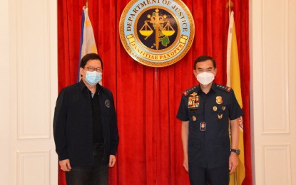 <p><strong>MEETING OF THE MINDS.</strong> Department of Justice Secretary Menardo Guevarra (left) and Philippine National Police chief, Gen. Guillermo Eleazar, meet on Friday (May 21, 2021) at the DOJ office in Manila. The agencies will collaborate in the investigation of 61 cases of alleged violations in anti-illegal drug operations. <em>(Photo courtesy of DOJ)</em></p>