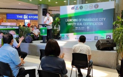 <p><strong>SAFETY SEAL CERTIFICATION</strong>. Parañaque City Mayor Edwin Olivarez speaks at the launching of Safety Seal Certification on Wednesday (May 26, 2021) in SM Mall Sucat. Olivarez said the safety seal will also help the city government to slowly open the economy "without sacrificing our health protocols." <em>(Photo courtesy of Parañaque PIO)</em></p>