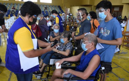 <p><strong>VACCINATION</strong>. Senior citizens in Palo, Leyte wait for their turn to receive the Covid-19 vaccine shot at a covered court in this May 25 photo. The local government unit here is optimistic to speed up its vaccine rollout through the online registration system. <em>(Photo courtesy of Palo local government)</em></p>