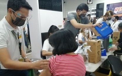 <p><strong>VACCINATED. </strong>Taguig residents avail of Covid-19 vaccines at the Lakeshore hub on May 5, 2021. The city government targets to fully vaccinate 650,000 residents by December 2021. <em>(PNA file photo by Lade Kabagani)</em></p>