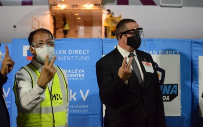 <p><strong>RUSSIAN DELIVERY.</strong> Vaccine czar Secretary Carlito Galvez Jr. (left) and Russian Ambassador to the Philippines Marat Pavlov welcome the arrival of 50,000 doses of Sputnik V vaccines at the Ninoy Aquino International Airport Terminal 3 on Sunday night (May 30, 2021). Another shipment of the Russian jabs is expected within the month. <em>(PNA photo by by Avito Dalan)</em></p>