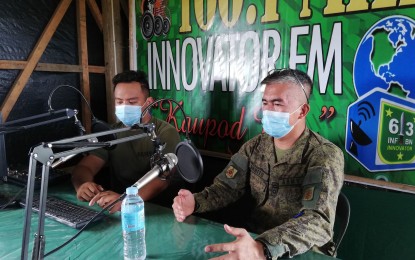 <p><strong>ON AIR</strong>. Philippine Army 63rd Infantry Battalion commander Lt. Col. Edgar Allan Orbito (right) during a radio program in this undated photo. The battalion is largely counting on its radio station to sustain peace efforts in far-flung communities of Basey, Samar, formerly influenced by the New People’s Army.<em> (PNA photo by Sarwell Meniano)</em></p>