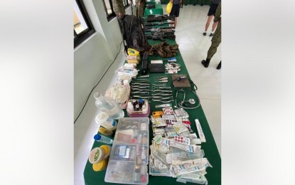 <p><strong>RECOVERED EVIDENCE</strong>. Government forces recover high-powered firearms, ammunition, and other pieces of evidence from New People's Army rebels during an encounter in Barangay New Israel Makilala, North Cotabato on May 20, 2021. Another encounter on May 21 also yielded various firearms wherein two fighters were arrested. <em>(Photo from 10ID)</em></p>