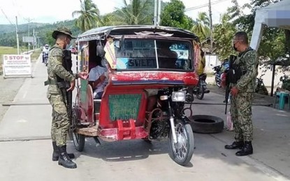 <p><strong>INSPECTION.</strong> Policemen manning a checkpoint in Zamboanga City check the passenger and driver of a tricycle in this undated photo. The city government has adopted the 'StaySafe' application as its official contact tracing system. <em>(Photo courtesy of City Hall Public Information Office)</em></p>