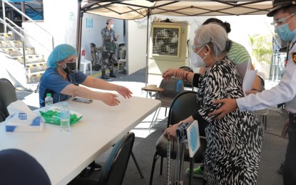 <p><strong>A2 SECTOR.</strong> A senior citizen is assisted in one of Quezon City's Covid-19 vaccination sites in this undated photo. Mayor Joy Belmonte is encouraging the elderly to get inoculated. <em>(Photo grabbed from QC Government Facebook)</em></p>