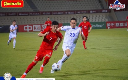 <p><strong>CRUCIAL MATCH.</strong> Wu Lei (left) is seen attacking against Martin Steuble (center) who scored the go-ahead penalty to help China defeat the Azkals in a pivotal FIFA World Cup Qualifiers match in Sharjah, UAE on Monday (June 7, 2021). China scored a 0-2 win over the Azkals.<em> (Photo courtesy of Philippine Football Federation)</em></p>