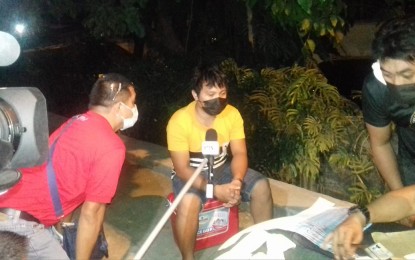 <p><strong>ARRESTED.</strong> Jaber Saranggani (center), 24, a resident of Jackfruit St. in Sasa, Davao City is interviewed after authorities seized an estimated PHP13.6 million worth of shabu from him during a buy-bust operation in Barangay Lasang, Davao City on Monday night (June 7, 2021). The suspect yielded an estimated PHP13.6 million worth of shabu.<em> (Photo from CDEU-SOG)</em></p>