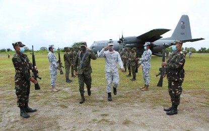 <p><strong>VISIT TO TROOPS.</strong> AFP Chief of Staff, Gen. Cirilito Sobejana (wearing garland), is given arrival honors during his visit to the Pag-asa Island on Monday (June 7, 2021). The visit aimed to boost the morale of troops securing the community and other areas within the Kalayaan Island Group. <em>(Photo courtesy of AFP Public Affairs Office)</em></p>