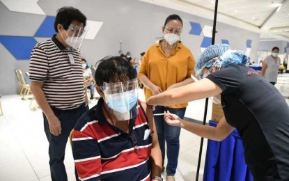 <p><br /><strong>COVID-19 VACCINATION</strong>. Bacolod City Mayor Evelio Leonardia (standing, left) and City Administrator Em Ang (right) observe the inoculation flow in the vaccination center set up at the SMX Convention Center inside the SM City Bacolod on Wednesday (June 9, 2021). So far, more than 39,000 doses of vaccines have already been administered to residents of the city. <em>(Photo courtesy of Bacolod City PIO)</em></p>