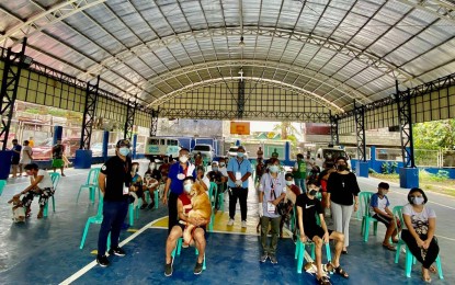 <p><strong>DIFFERENT VAX.</strong> Owners and their pets practice physical distancing during an anti-rabies vaccination activity in Barangay Payatas, Quezon City on Wednesday (June 9, 2021). About 400 pets benefitted from the free inoculation. <em>(Photo courtesy of QC-PIO)</em></p>