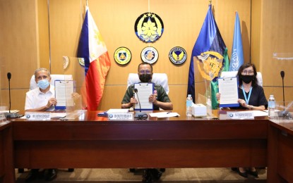 <p><strong>CHILD PROTECTION PLAN.</strong> Armed Forces of the Philippines chief-of-staff, Gen. Cirilito Sobejana (center) and representatives of United Nations (UN) bodies in the Philippines show a copy of a strategic plan to protect children in armed conflict during a signing ceremony in Camp Aguinaldo on Wednesday (June 9, 2021). Also in the photo are UN resident coordinator and co-chair of UN Country Task Force on Monitoring and Reporting (UN-CTFMR) Gustavo Gonzales (left) and United Nations Children's Fund (UNICEF) representative to the Philippines Oyunsaikhan Dendevnorov (right). <em>(Photo courtesy of AFP Public Affairs Office)</em></p>