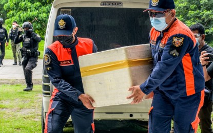 <p><strong>MORE JABS.</strong> Bureau of Fire Protection personnel in General Santos City carry one of the two cooler boxes containing Sinovac vaccines that arrived before noon Wednesday (June 9, 2021) at the cold chain facility in the city gymnasium. The city received an additional 2,750 doses of the Chinese-made jabs that are intended for the remaining eligible individuals under priority groups A1, A2, and A3. <em>(Photo courtesy of the city government)</em></p>