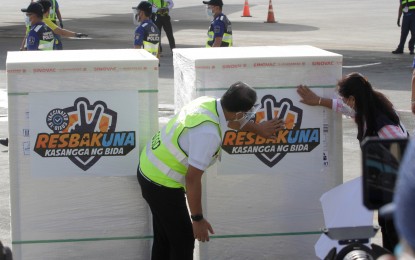 <p><strong>NO INEQUALITY</strong>. Vaccine czar Secretary Carlito Galvez Jr. (left), together with DOH Undersecretary Ma. Carolina Vidal-Taino (2nd from right), places a "Resbakuna" sticker on one of the boxes containing another 1 million doses of Sinovac vaccine at the NAIA Terminal 2 in Pasay City on Thursday (June 10, 2021). Malacañang on Thursday said there is no inequality in the distribution of the Covid-19 vaccines in the country. <em>(PNA photo by Avito C. Dalan)</em></p>