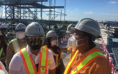 <p><strong>INSPECTION</strong>. Department of Transportation (DOTr) Secretary Arthur Tugade (right), together with Bulacan Governor Daniel Fernando (left) and other DOTr officials, inspect the erected segments and completed span at the Balagtas Station of the Philippine National Railways (PNR) Clark Phase I Project in Barangay Borol 1st, Balagtas, Bulacan on Monday (June 14, 2021). The project that will cross the cities of Manila, Caloocan, Valenzuela, and the municipalities of Meycauayan, Marilao, Bocaue, Balagtas, Guiguinto, and Malolos City is expected to be completed by the second quarter of 2024. <em>(Photo by Manny Balbin)</em></p>