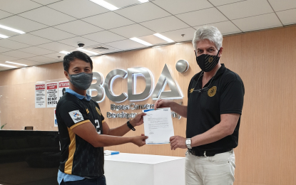 <p><strong>RENAMED</strong>. Arrey A. Perez (left), Senior Vice President Corporate Services Group handing over the Bases Conversion Development Authority (BCDA) endorsement letter to Eric M. Gottschalk, President of United City FC, in this undated photo. United City, reigning Philippines Football League (PFL) champion, has been renamed United Clark. <em>(Photo courtesy of United City FC)</em></p>