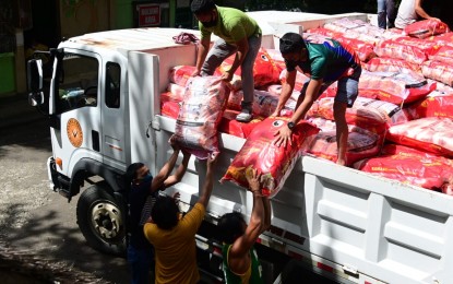 <p><strong>FOOD AID.</strong> Sacks of rice intended for the Davao City first district fisherfolk are unloaded from a truck on Saturday (June 12, 2021). Davao City 1st District Rep. Paolo "Pulong" Duterte distributed over the weekend some 10 kilos of rice to each fisherfolk in the first district. <em>(Photo courtesy of 1st District Rep. Paolo 'Pulong' Duterte's office)</em></p>