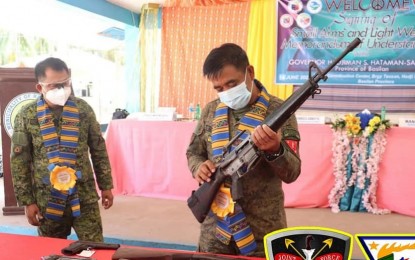 <p><strong>LOOSE FIREARMS.</strong> Brig. Gen. Domingo Gobay, 101st Infantry Brigade commander, inspects one of the loose firearms that officials of Hadji Muhtamad town turned over on Monday (June 14, 2021). Municipal officials signed a memorandum of understanding in support of the Small Arms and Light Weapons program. <em>(Photo courtesy of 101st IB)</em></p>