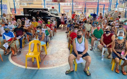 <p><strong>LGU ASSISTANCE.</strong> Elderly residents of a Manila village converge on a basketball court during the distribution of cash assistance from the city government in this April 2021 photo. Citizens aged 60 and above and those with disabilities regardless of age enjoy a 20-percent discount on transportation, food, and medicines. <em>(Photo courtesy of Manila-PIO)</em></p>