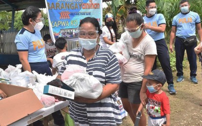 <p><strong>'BARANGAYANIHAN'.</strong> Caraga residents queue up to get food and other essentials in this undated photo. More than PHP10.3 million worth of goods and pandemic essentials were distributed by the different police stations and units during a series of Barangayanihan Help and Food Bank (Barangayanihan) activities conducted from April 23 to June 12. <em>(Photo courtesy of PRO-13 Information Office)</em></p>