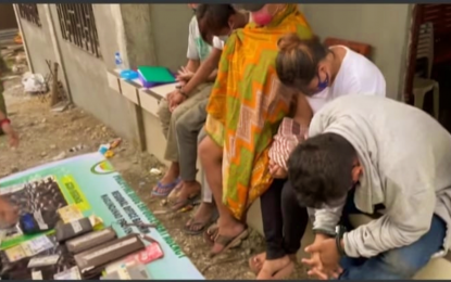 <p><strong>NABBED.</strong> Five suspects cover their faces as PDEA agents account for the suspected shabu items seized from them in Datu Odin Sinsuat, Maguindanao on Tuesday (June 15, 2021). Some 20 grams of shabu with an estimated street value of PHP136,000 were seized from the suspects. <em>(Photo courtesy of PDEA-BARMM)</em></p>