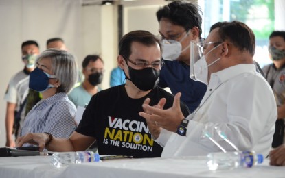 <p><strong>GET WELL SOON</strong>. Manila Mayor Francisco “Isko Moreno” Domagoso chats with Presidential Spokesperson Harry Roque during the vaccination rollout for seafarers at the Palacio de Maynila in Roxas Boulevard in this undated photo. Roque on Monday (Aug. 16, 2021) wished Domagoso a speedy recovery after he tested positive for Covid-19. <em>(PNA photo by Avito C. Dalan)</em></p>