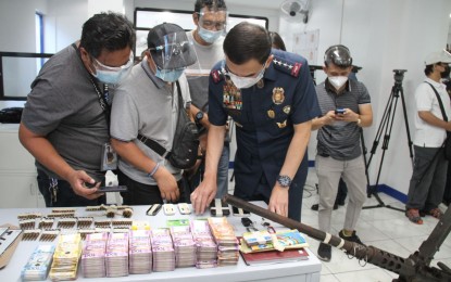 <p><strong>NARCO MAYOR KILLED.</strong> PNP chief, Gen. Guillermo Eleazar presents items seized from former Talitay, Maguindanao mayor Montasser Sabal in a press briefing on Thursday (June 17, 2021). Sabal was killed after allegedly grabbing the gun of a police escort while en route to Camp Crame, Quezon City hours after he was arrested by CIDG members at the Batangas Port in Batangas City. <em>(Photo courtesy of PNP)</em></p>