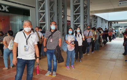 <p><strong>QUEUE FOR JABS.</strong> Civil Aviation Authority of the Philippines central office employees queue at the Mall of Asia giga vaccination hub in Pasay City on Friday (June 18, 2021). Seventy-five front-liners were inoculated.<em> (Photo courtesy of CAAP)</em></p>