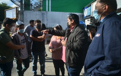 <p><strong>OPERATIONS.</strong> Anti-Red Tape Authority head Secretary Jeremiah Belgica (2nd from right) gathers information from workers around the Land Transportation Office main office on East Avenue, Quezon City on June 15, 2021. Belgica and his team posted reminders not to patronize and report fixers after his undersecretary, retired Brig. Gen. Carlos Quita, was himself victimized. <em>(PNA photo by Robert Oswald P. Alfiler)</em></p>