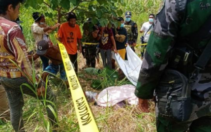 <p><strong>BLAST CASUALTY</strong>. Police and community leaders view the remains of Rosita Kenendi, 21, a pregnant mother, hit by shrapnel in an explosion in Datu Hofer, Maguindanao Wednesday dawn (June 23, 2021). Two children of the expectant mother were hurt in the blast. <em>(Photo courtesy of PRO-BARMM)</em></p>