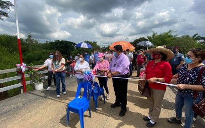 <p><strong>INAUGURATION</strong>. Department of Agrarian Reform (DAR) Secretary John Castriciones (center) Nueva Ecija's 4th District Rep. Maricel Nagaño (2nd from left), Palayan City Mayor Adrianne Mae Cuevas (extreme left), and other DAR officials cut the ribbon for the inauguration of San Mariano-Barrio Militar bridge on Tuesday (June 22, 2021). This is one of the two bridges formally opened in Peñaranda, Nueva Ecija on Tuesday. <em>(Contributed photo)</em></p>