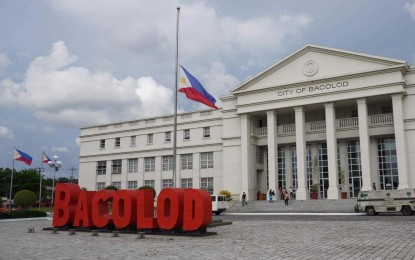 <p><strong>IN MOURNING</strong>. The Philippine flag is flown at half-staff at the Bacolod City Government Center grounds as Bacolodnons joined the nation in mourning the death of former president Benigno Simeon Aquino III on Thursday (June 24, 2021). Mayor Evelio Leonardia issued Executive Order 33, series of 2021, ordering to fly the flags at half-staff in all public buildings and places in the city for 10 days or from June 24 to July 3.<em> (Photo courtesy of Bacolod City PIO)</em></p>
