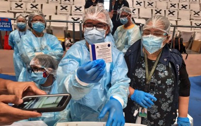 <p><strong>INOCULATION.</strong> Makati health care workers display the Sputnik V Covid-19 vaccine during the initial rollout at the Makati Coliseum in early May 2021. Mayor Abby Binay and the National Task Force apologized after an incident on June 25 when a volunteer nurse in the city ‘forgot’ to fully inject the jab.<em> (PNA file photo)</em></p>