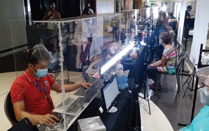 <p><strong>BIOMETRICS COLLECTION.</strong> Applicants for the Philippine Identification card have their biometrics taken at a Manila mall in this June 2021 photo. The Step 2 process involves the recording of fingerprint and iris scans and taking of front-faced photographs. <em>(Photo courtesy of Manila Civil Registry)</em></p>