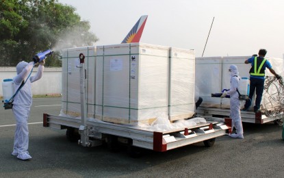 <p><strong>DISINFECTED.</strong> Crates containing Sinovac vaccines are thoroughly disinfected upon arrival at the Ninoy Aquino International Airport in Pasay City on Monday (June 28, 2021). The one million doses of the China-made jabs were taken to a cold storage facility in Marikina City. <em>(PNA photo by Dexter Starks)</em></p>