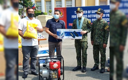<p><strong>TURN-OVER</strong>. PNP chief Gen. Guillermo Eleazar (2nd from right) receives various equipment from the provincial government of Pangasinan through Governor Amado Espino III (2nd from left) on Wednesday (June 30, 2021) in front of the provincial capitol in Lingayen, Pangasinan. The equipment will be used in the different programs and duties of the Pangasinan police.<em> (Photo by Hilda Austria)</em></p>