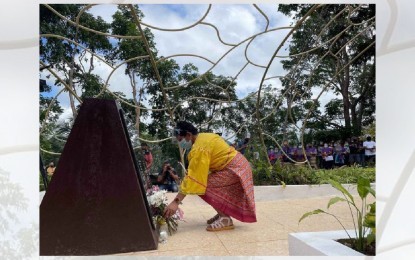 <p><strong>HONORING THE VICTIMS</strong>. A member of the Bagobo-Tagabawa tribe offers candles and flowers at the Rano Monument on Friday (June 25, 2021) to commemorate the 32nd anniversary of the June 25, 1989 massacre in Digos City. The tragedy left 39 individuals – 22 children, 10 women, and seven men – killed on the spot. <em>(PNA photo by Che Palicte)</em></p>